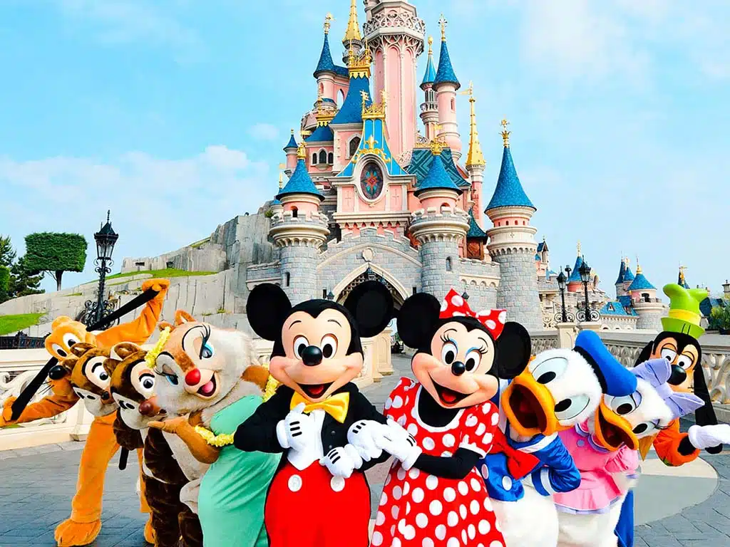 The Disney characters in front of the castle in Disneyland Paris